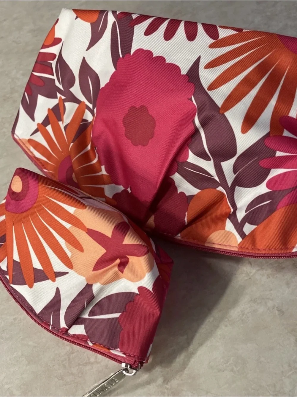 Clinique maroon, orange, pink, and white floral makeup bags #makeup #floral